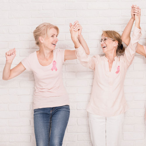 Two Breast Cancer Survivors holding hands